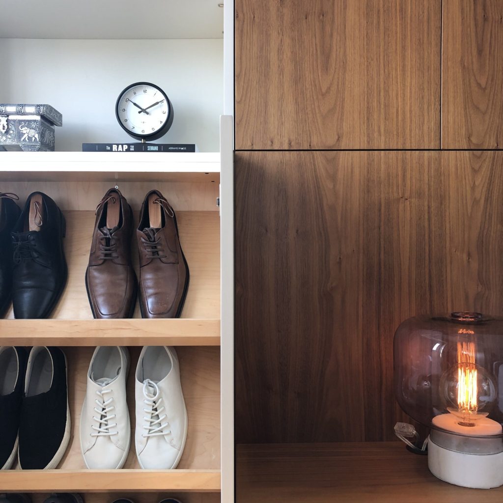 Create order in your surroundings: wood night stand with shoe rack and shelfs to the left.