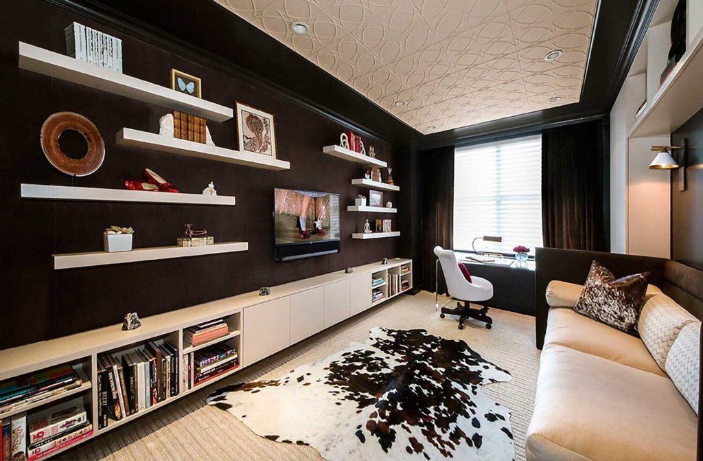 Designing your home office: dark brown walls with white floor, ceiling and shelves, white sofa and animal hide rug.